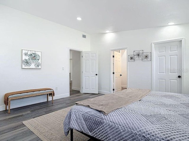 bedroom featuring recessed lighting, visible vents, baseboards, and wood finished floors