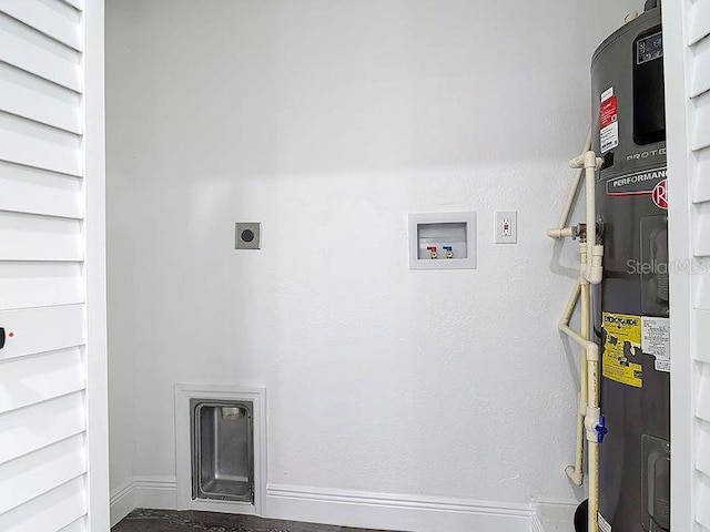 laundry area with laundry area, heat pump water heater, baseboards, washer hookup, and electric dryer hookup