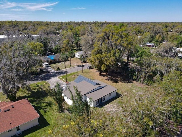 birds eye view of property with a wooded view