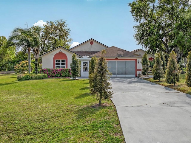 ranch-style house with a front yard, concrete driveway, a garage, and stucco siding