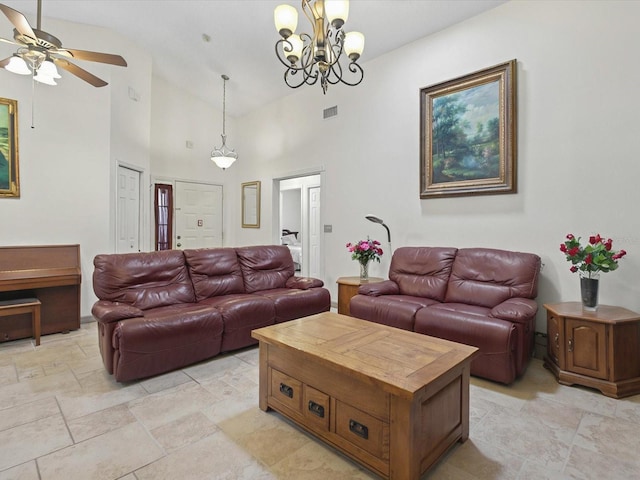 living area featuring visible vents, high vaulted ceiling, and ceiling fan with notable chandelier