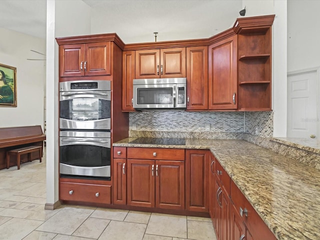 kitchen featuring light stone counters, decorative backsplash, appliances with stainless steel finishes, and open shelves