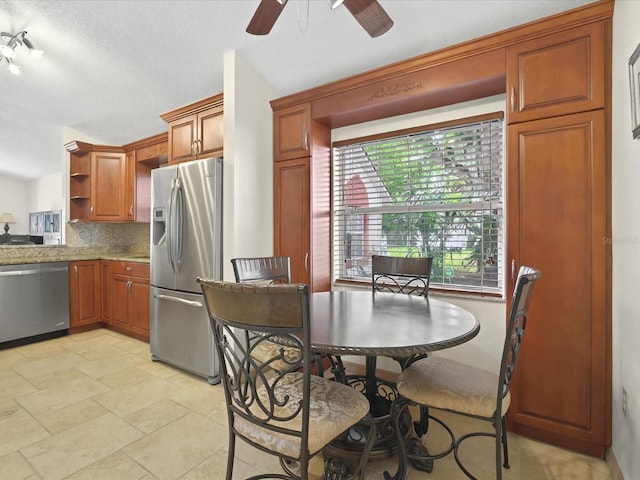 dining space featuring a textured ceiling and ceiling fan