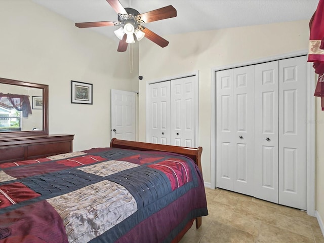 bedroom with baseboards, multiple closets, high vaulted ceiling, and a ceiling fan