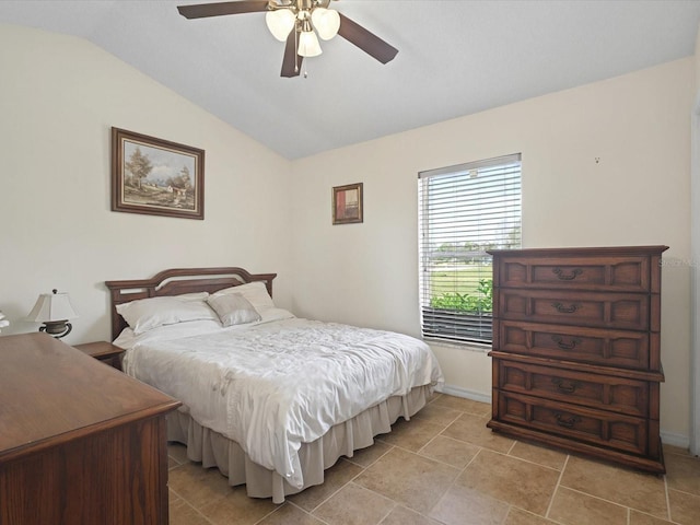 bedroom with ceiling fan, baseboards, and lofted ceiling