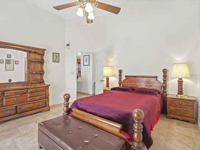 bedroom featuring light tile patterned flooring, a ceiling fan, and baseboards