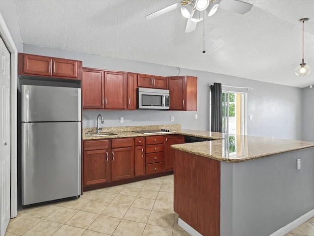 kitchen with light tile patterned floors, light stone countertops, appliances with stainless steel finishes, and a sink