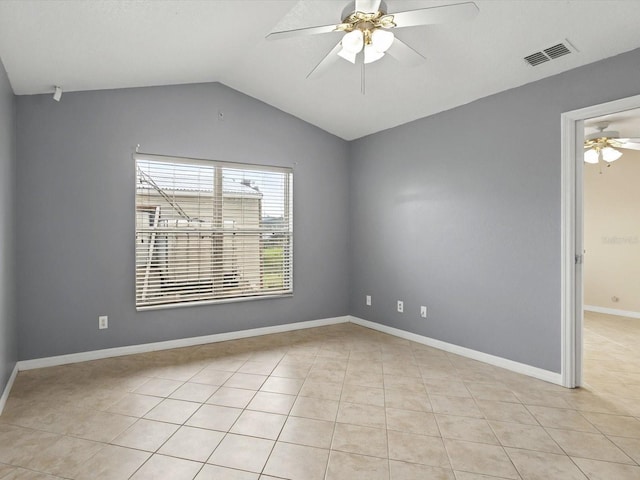 spare room with visible vents, baseboards, vaulted ceiling, light tile patterned flooring, and a ceiling fan