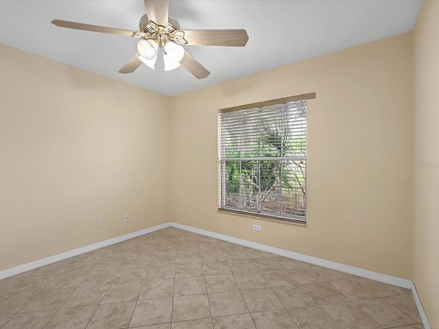 unfurnished room featuring light tile patterned floors, ceiling fan, and baseboards