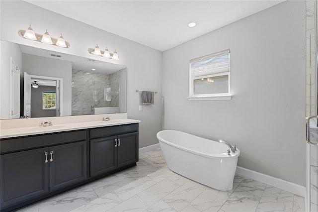 full bathroom with baseboards, a marble finish shower, a wealth of natural light, and a sink