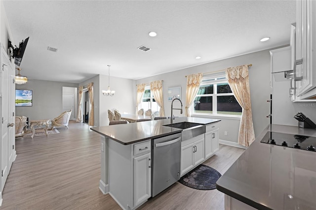 kitchen with visible vents, a sink, light wood-style floors, stainless steel dishwasher, and black electric cooktop