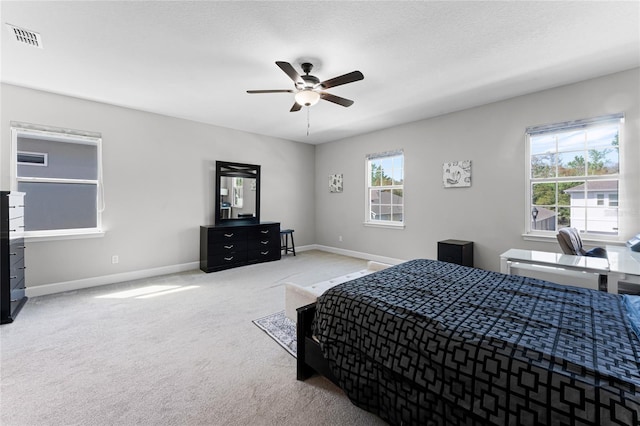 bedroom with visible vents, baseboards, carpet, and a ceiling fan