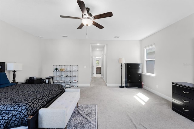 carpeted bedroom with visible vents, multiple windows, and baseboards