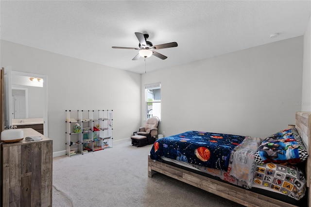 bedroom with baseboards, carpet floors, a textured ceiling, and a ceiling fan