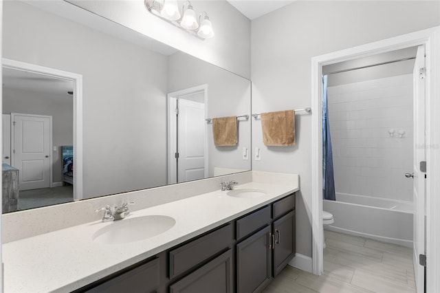 bathroom with double vanity, toilet, shower / tub combo with curtain, and a sink