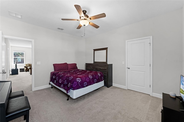 carpeted bedroom with visible vents, baseboards, and ceiling fan