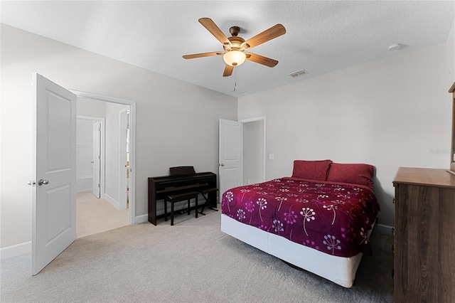 bedroom featuring visible vents, a ceiling fan, a textured ceiling, carpet floors, and baseboards