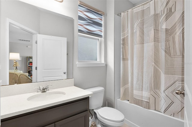 bathroom featuring visible vents, shower / bath combo with shower curtain, toilet, and vanity