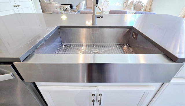 interior details with white cabinets and a sink