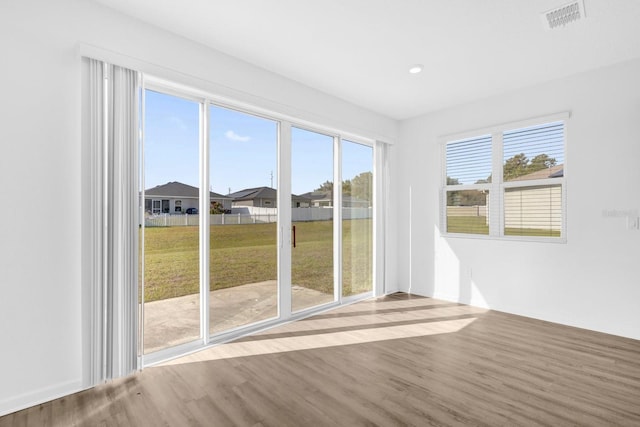 unfurnished sunroom with visible vents