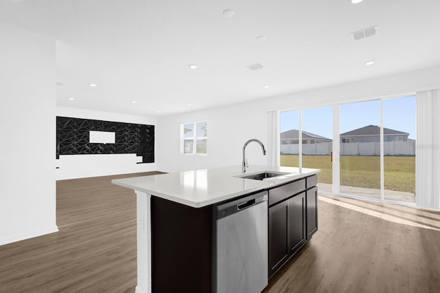 kitchen with visible vents, a sink, wood finished floors, light countertops, and dishwasher