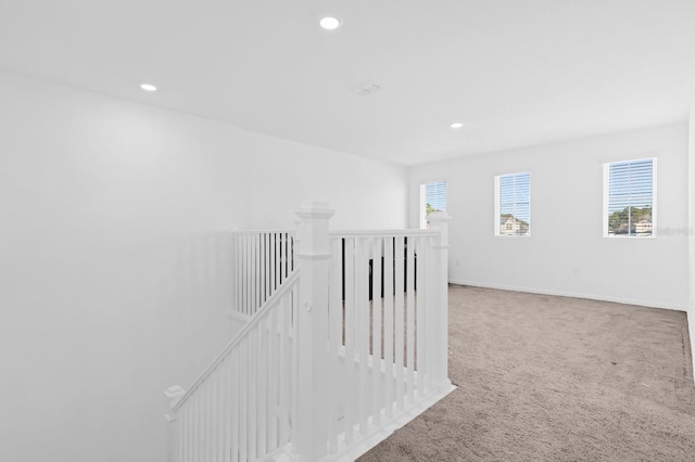 corridor featuring an upstairs landing, recessed lighting, baseboards, and carpet floors