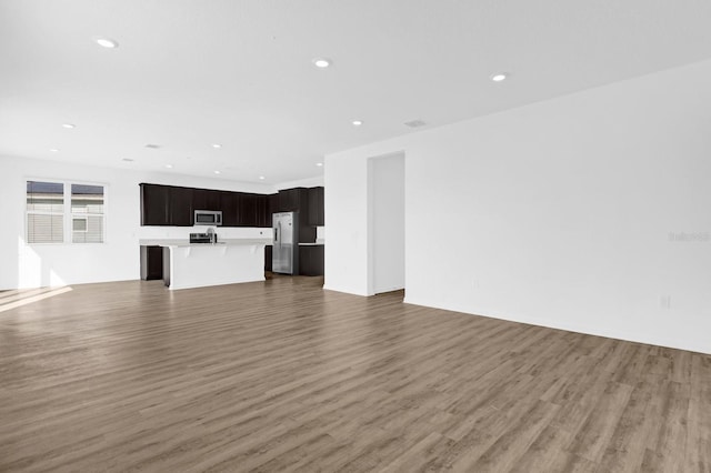 unfurnished living room with recessed lighting and light wood-style floors