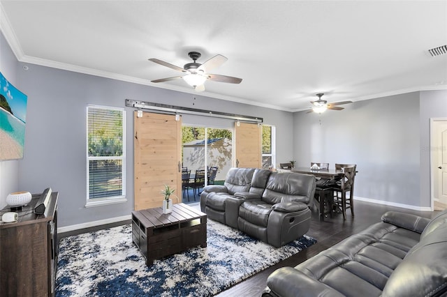 living room with visible vents, baseboards, wood finished floors, and crown molding