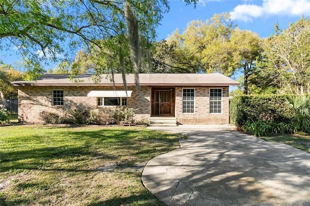 single story home with brick siding and a front lawn