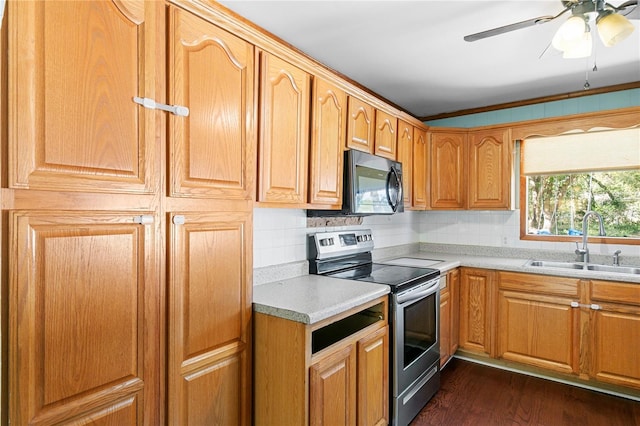 kitchen with dark wood-style floors, a sink, decorative backsplash, light countertops, and stainless steel range with electric cooktop