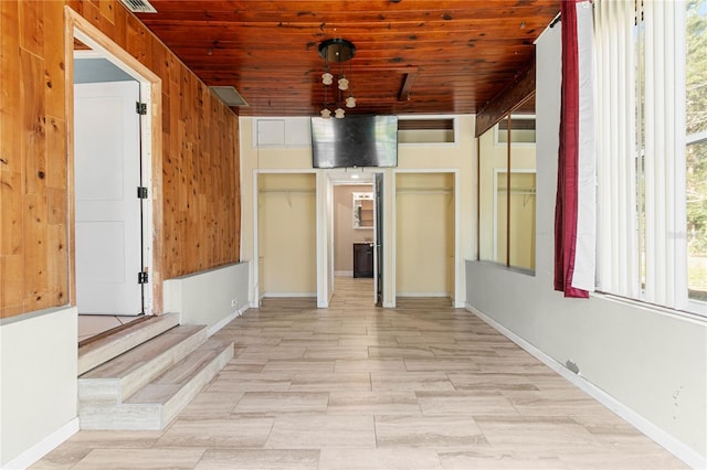 spare room with visible vents, wood ceiling, and baseboards