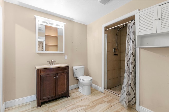 bathroom with vanity, baseboards, wood finish floors, a shower stall, and toilet