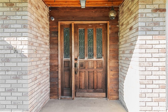 entrance to property with brick siding