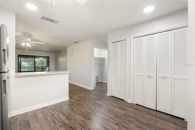 kitchen featuring visible vents, baseboards, ceiling fan, and dark wood-style flooring