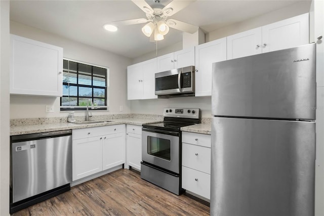 kitchen featuring a sink, stainless steel appliances, dark wood-style floors, and white cabinets