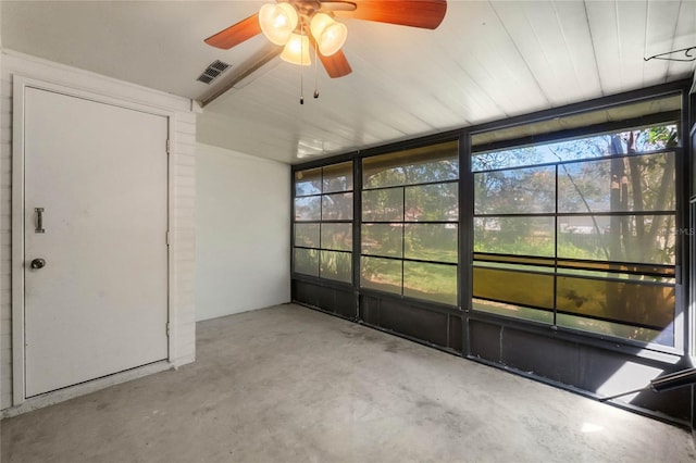 unfurnished sunroom with visible vents and a ceiling fan