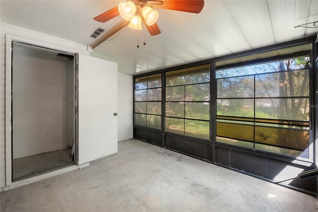 unfurnished sunroom with a ceiling fan and visible vents