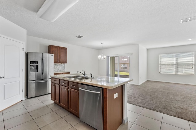 kitchen with light carpet, visible vents, stainless steel appliances, light countertops, and a sink