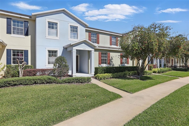 view of front of property featuring a front yard and stucco siding