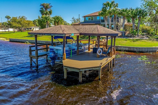 dock area featuring a lawn, a water view, and boat lift