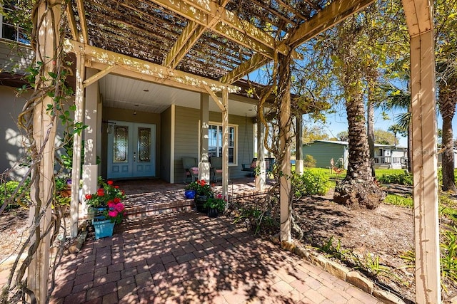 view of patio / terrace with french doors and a pergola