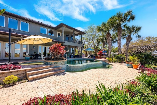 pool with french doors and a patio area