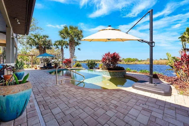 outdoor pool featuring a patio area and a water view