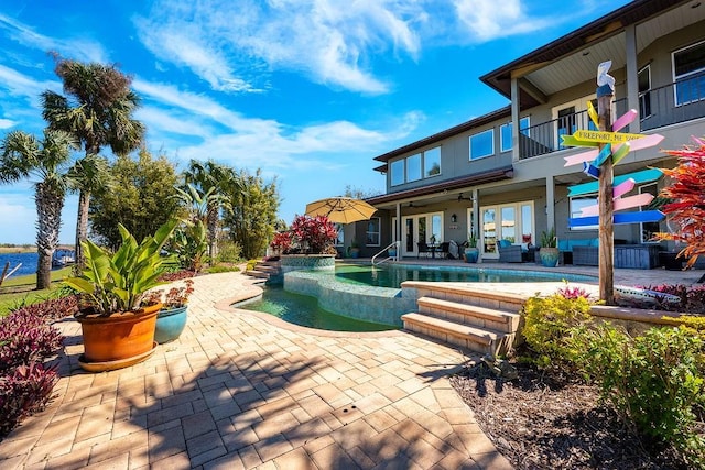 pool featuring french doors, a ceiling fan, and a patio area