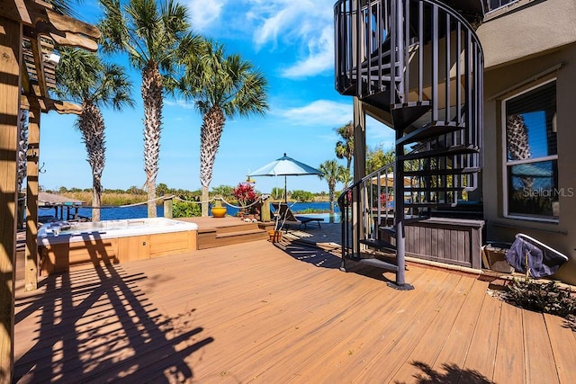 wooden terrace with a jacuzzi and stairs