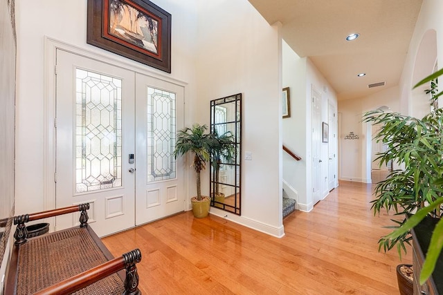 foyer entrance with light wood-type flooring, visible vents, recessed lighting, stairway, and baseboards