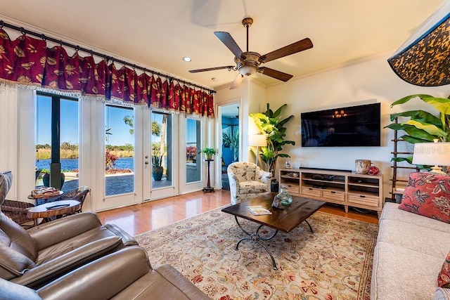 living area featuring recessed lighting, wood finished floors, ornamental molding, and a ceiling fan