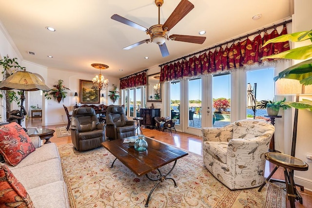 living area with visible vents, ceiling fan with notable chandelier, recessed lighting, french doors, and baseboards