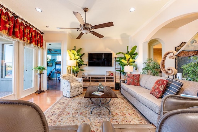 living room featuring recessed lighting, wood finished floors, a ceiling fan, and ornamental molding