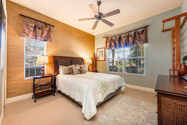 carpeted bedroom with baseboards and a ceiling fan